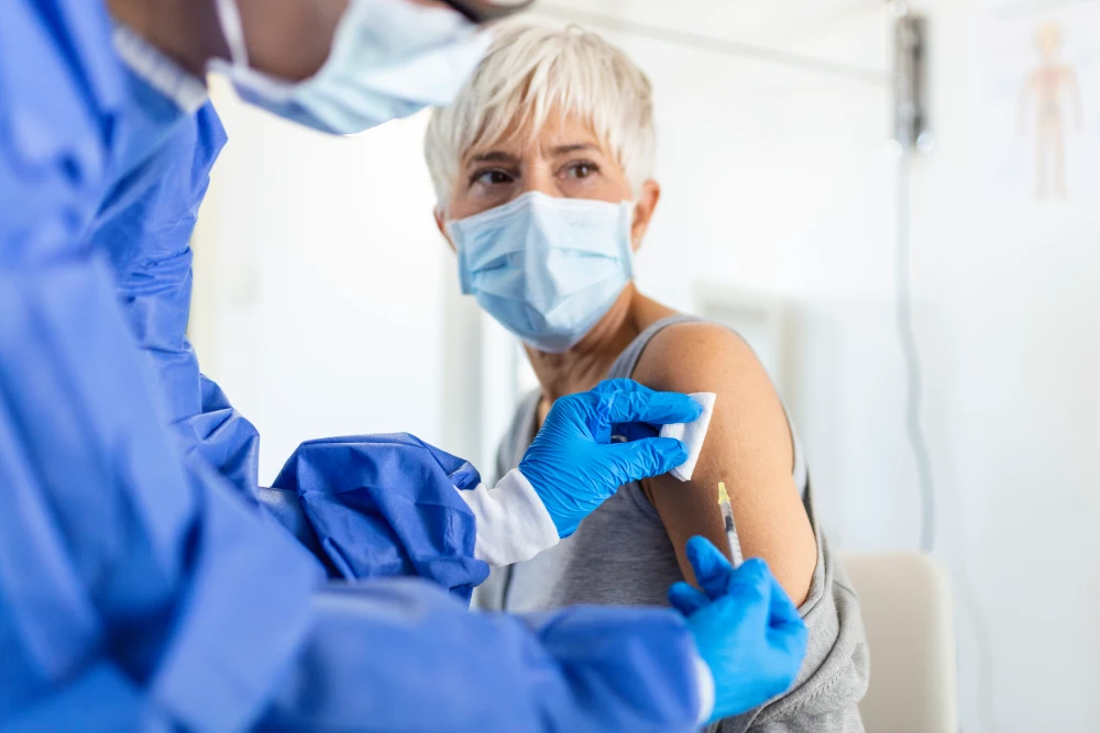doctor holding syringe making covid 19 vaccination